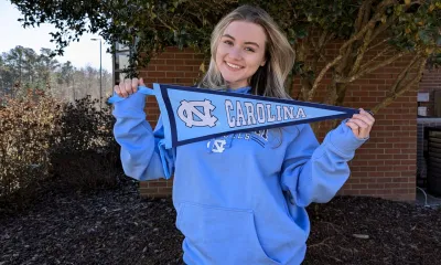 Madison Gentry holds up a pennant for UNC-CH.